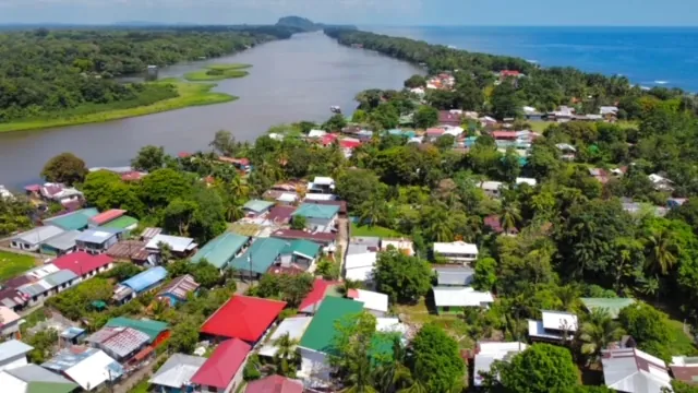 Aerial view of Tortuguero Village between the canal and the Caribbean Sea